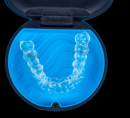 Clear Invisalign aligner held up close, ready to wear